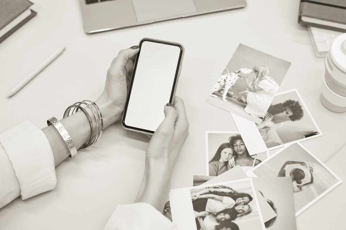 A phone beside a small photo printer feeding out a finished print
